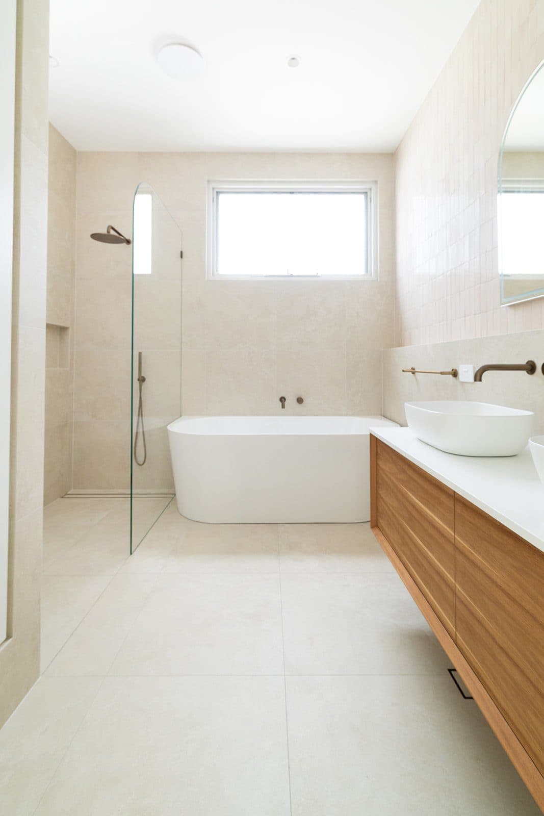 Main bathroom — freestanding bath, timber vanity and skylight