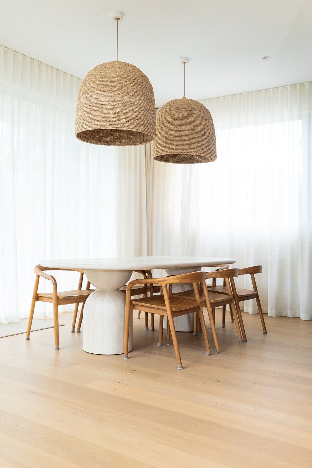 Dining space under woven pendant lights
