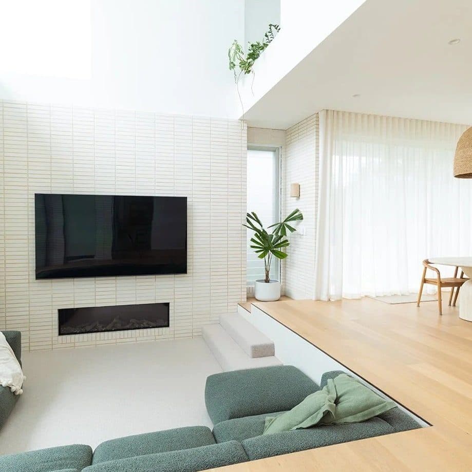 Textured tile fireplace wall with inset TV and sunken lounge