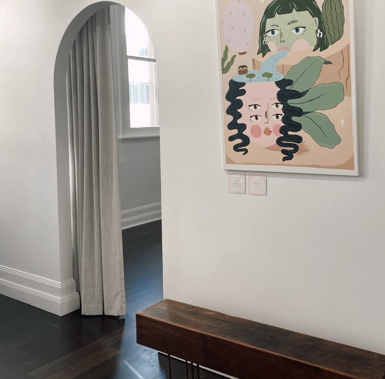 Studio corner — heritage arch, artwork and dark floors