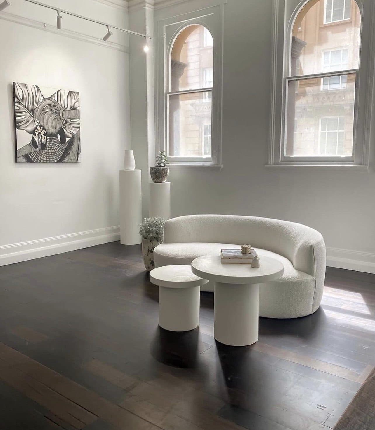 The studio's front room — arched sash windows and curved lounge