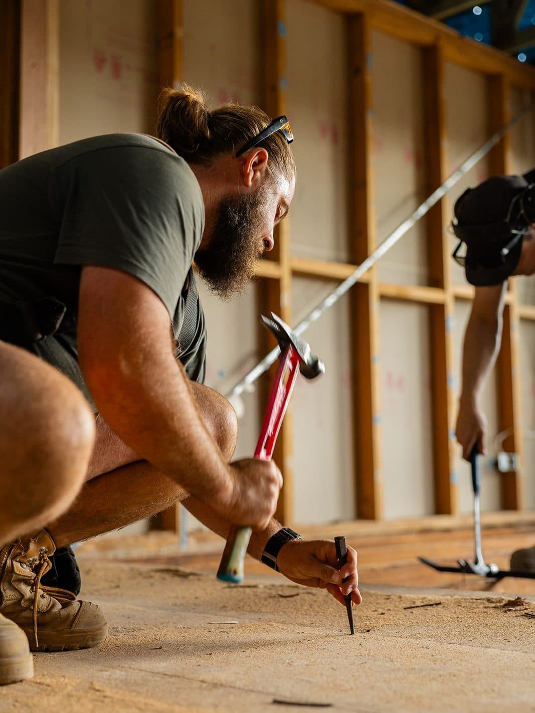 Levering out old floorboards during demolition