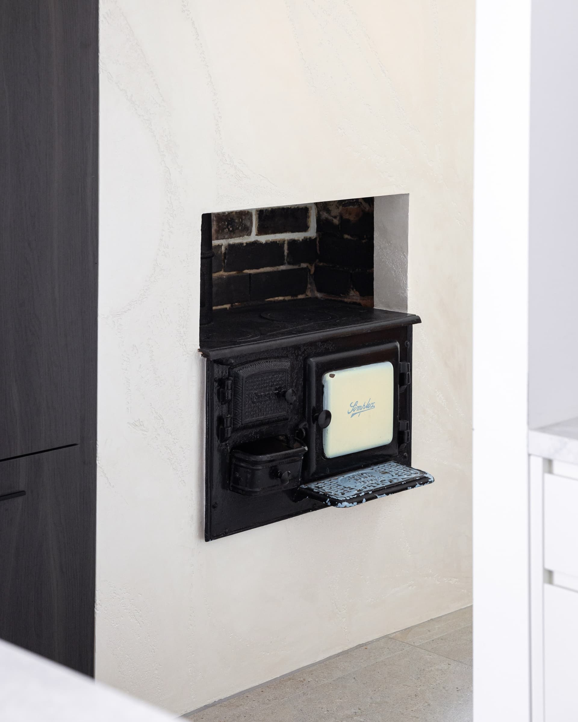 The original cast-iron cooker, restored and kept in the new kitchen wall