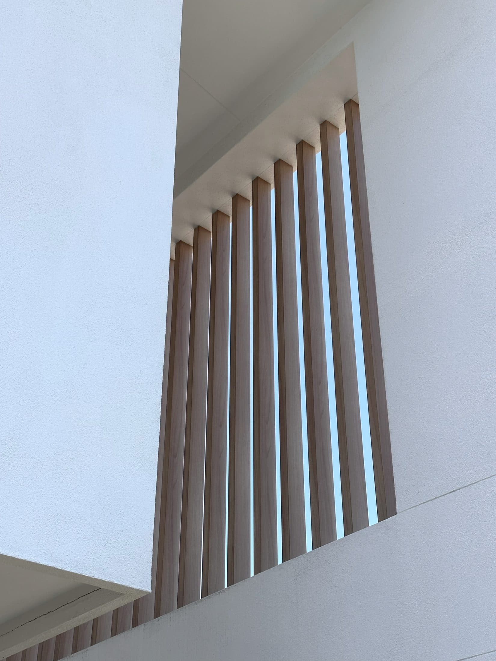 Timber batten screen detail against white render