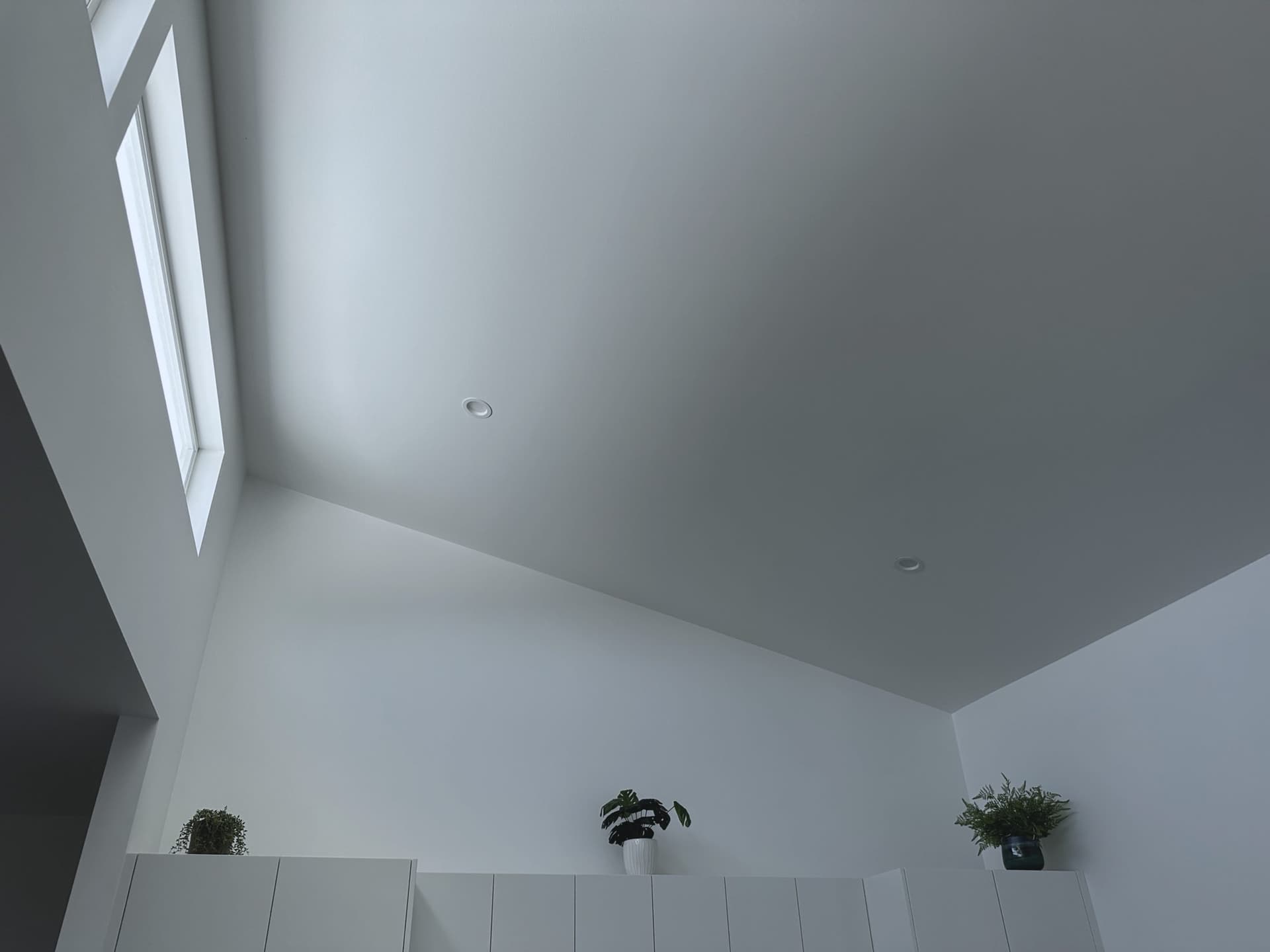 Cathedral ceiling planes meeting above the living space