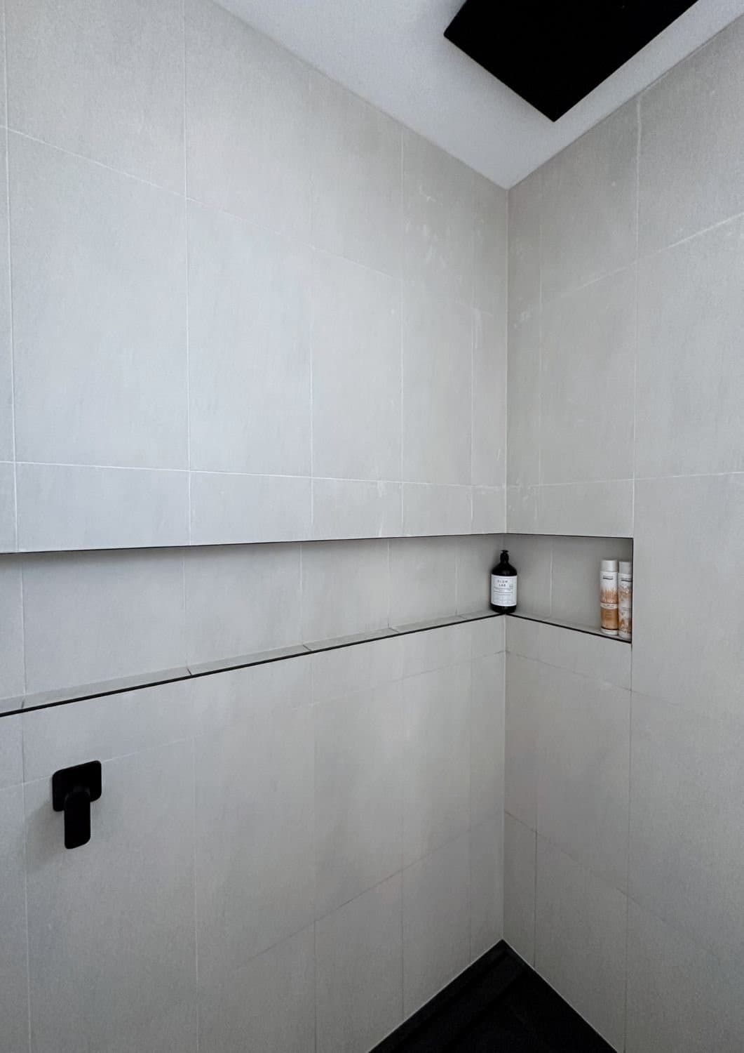 Ensuite in grey stone tile with timber vanity