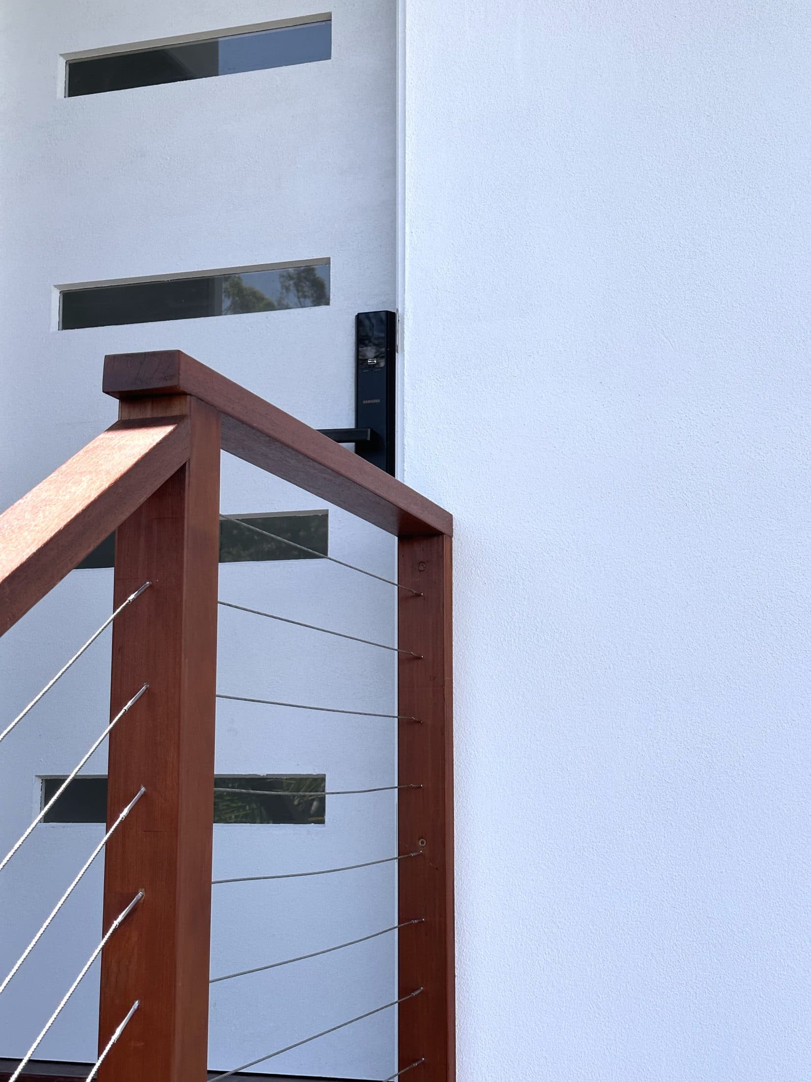 Entry with vertical slot windows and timber handrail