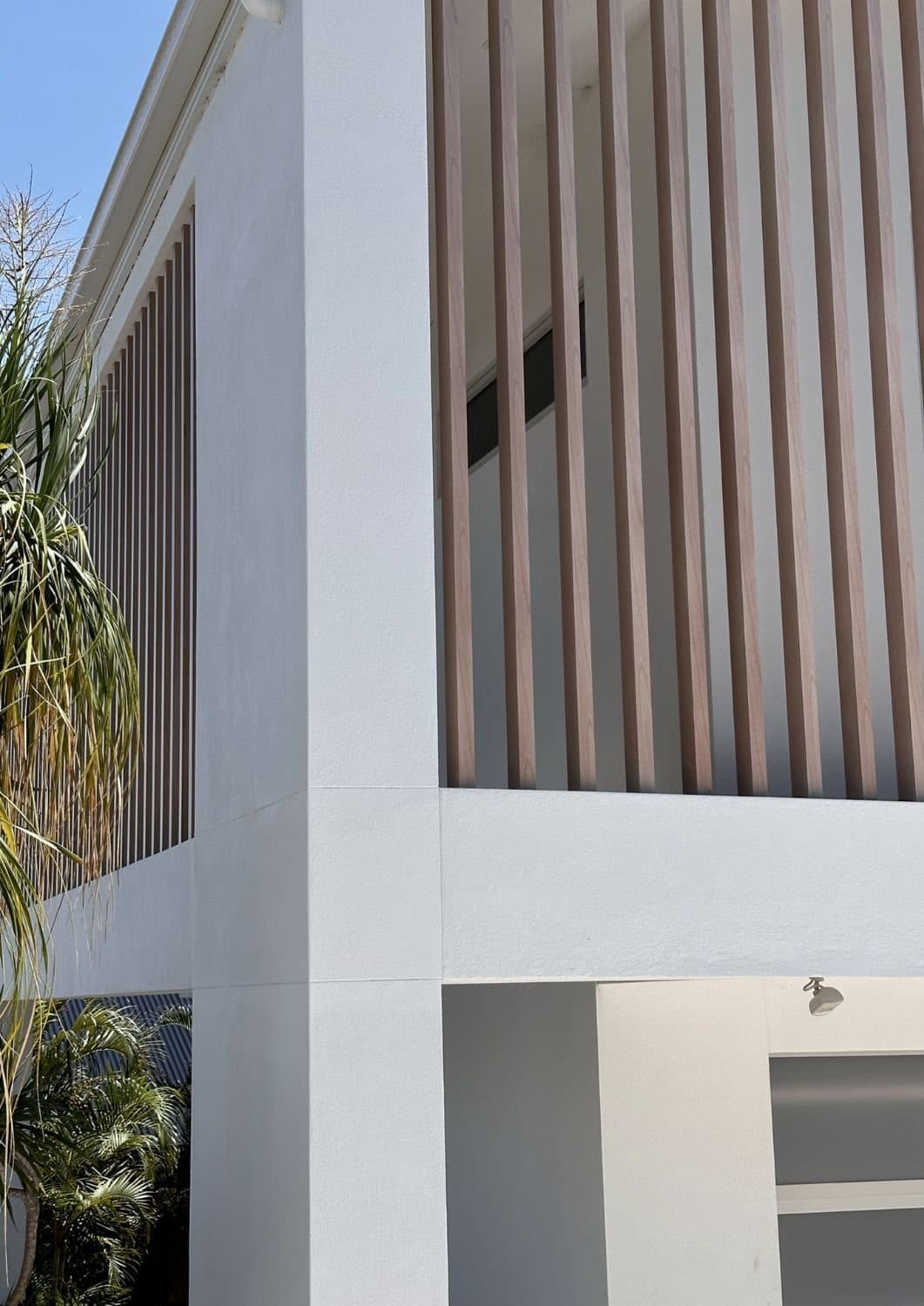 Facade detail — vertical timber battens over the entry