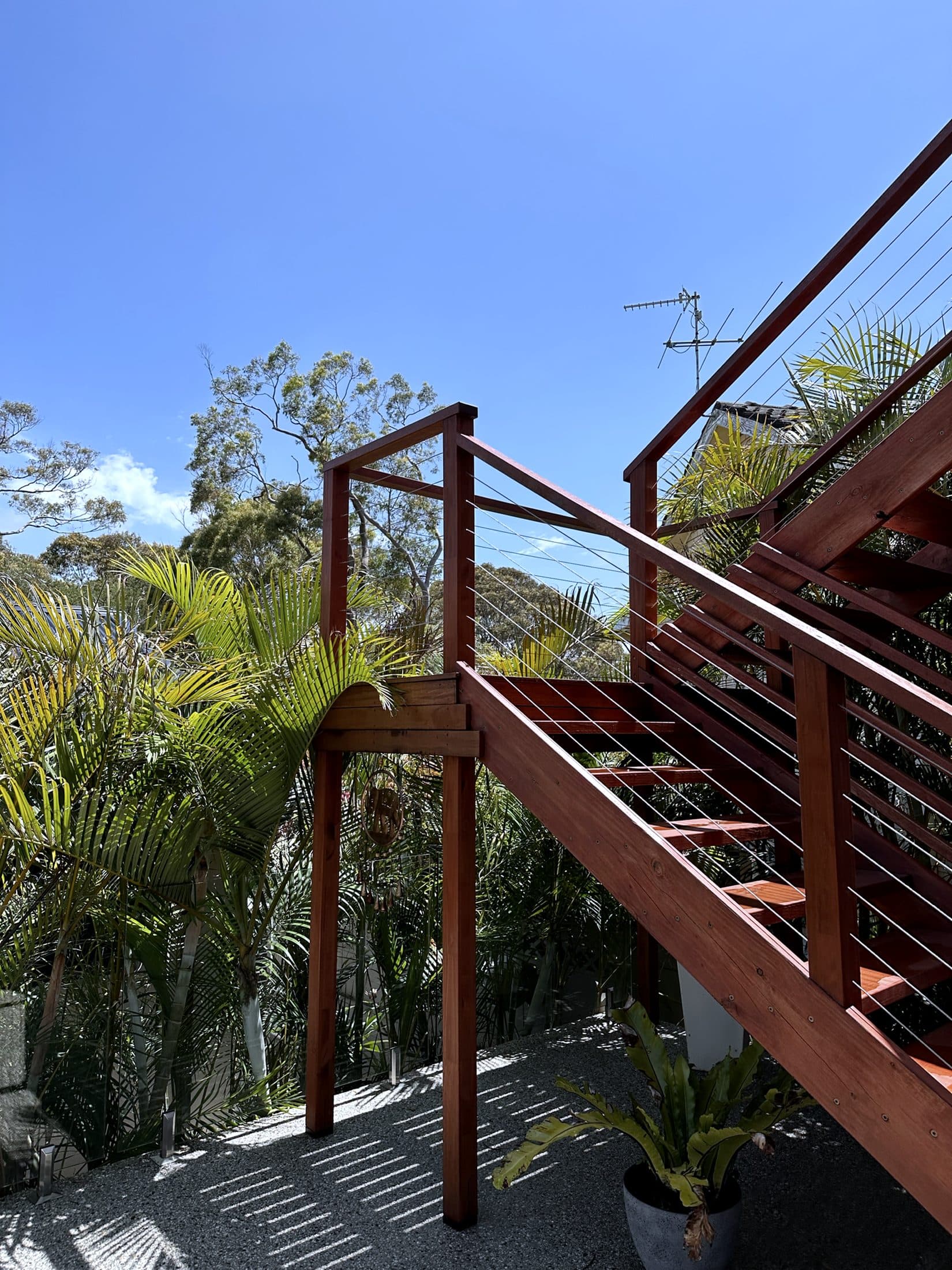 External timber-and-steel stair against the rendered wall
