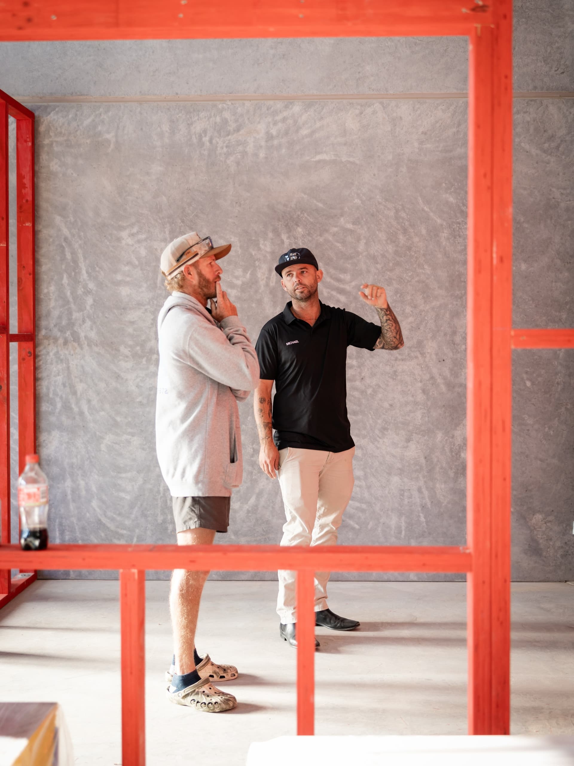 Michael Bell directing work on site inside a framed build